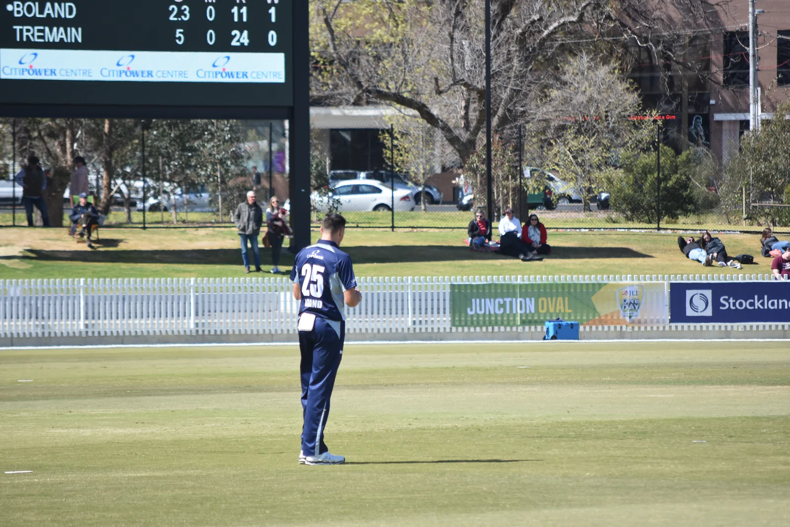 Cricket at Junction Oval in St Kilda during Victoria versus South Australia on 30 September 2018, with the scoreboard and boundary fence visible.